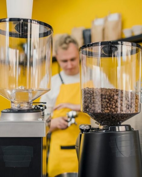 front-view-male-barista-with-apron-shop_23-2148523058